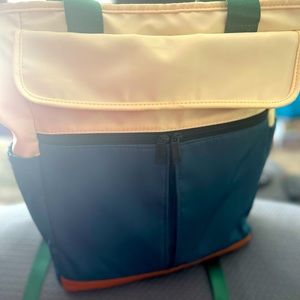 Green and cream laptop backpack and or purse.  Can carry a 15 inch laptop